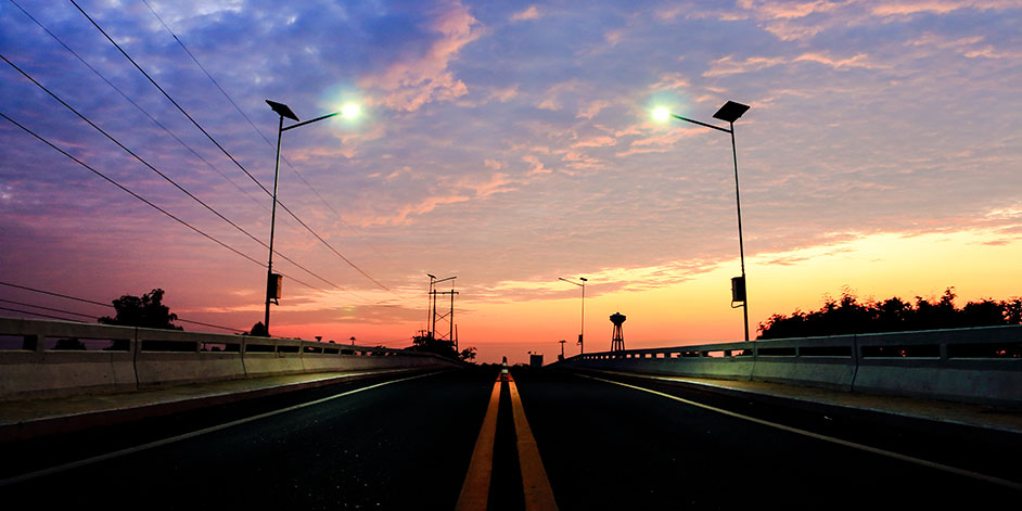 Streetlights over roadway at dusk