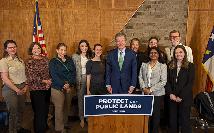 People including Roy Cooper, Katie Warnell, Lydia Olander at Governor’s executive order on natural and working lands 