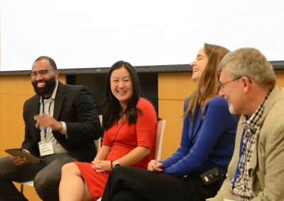 Panelists laughing during a presentation