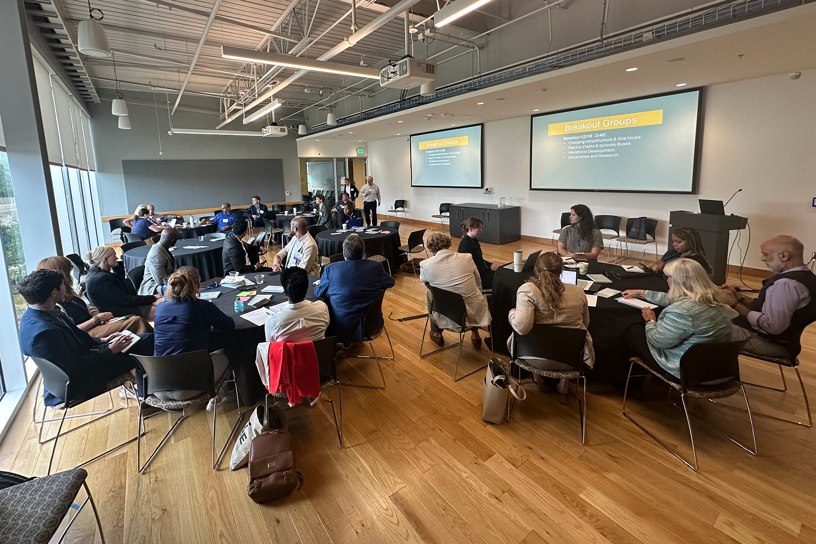 Participants at the June 2024 SETRI meeting sit at a series of round tables