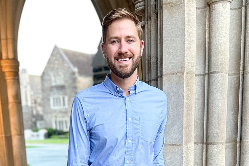 Tyler Norris in front of the arch of a building on Duke's campus